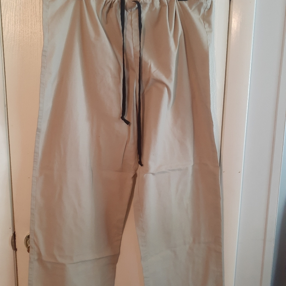 Tan scrub pants with black drawstring